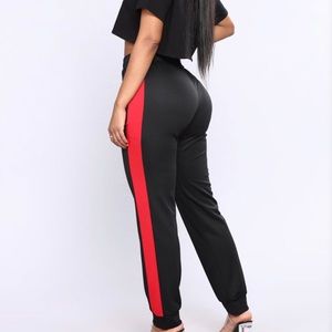 Black jogger pants with red stripe